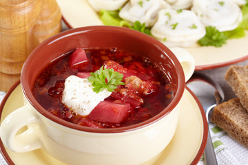 Russian cuisine. Borscht and pelmeni on the served table