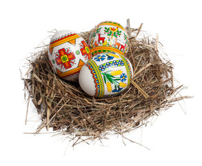 Easter eggs in nest isolated on white