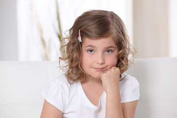 Young girl sitting on a sofa