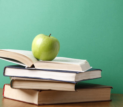An apple on a pile of books