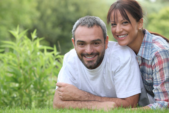 Couple lying in grass