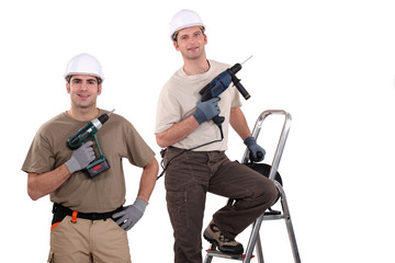 Workmen holding their electric screwdrivers