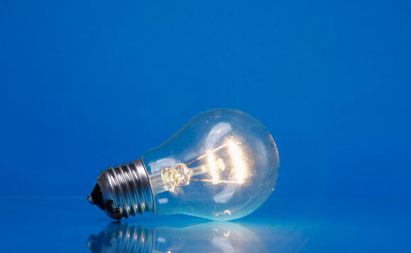 A light bulb, isolated on blue