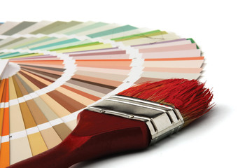 Close-up of a color palette and a brush on white background