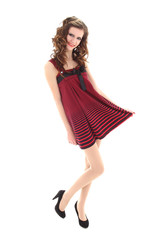 teenager in red dress posing over white