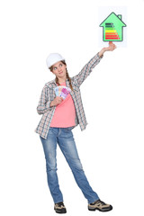 Woman holding energy rating sign