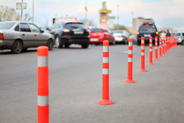 protective barrier made of red striped columns on road
