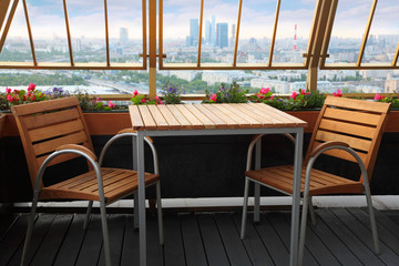 Wooden chairs and table at terrace in empty restaurant