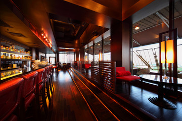 Row of tables, seats and bar counter with chairs in restaurant - obrazy, fototapety, plakaty
