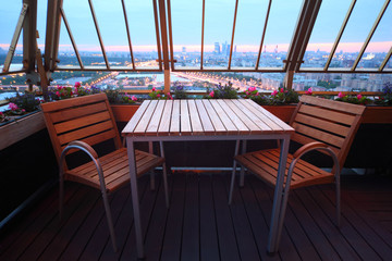 Wooden chairs and table at terrace in empty restaurant