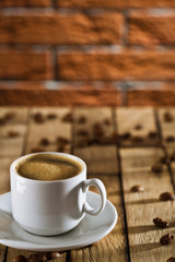 cup with espresso on the wooden boards