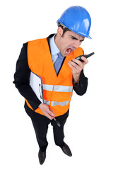 Engineer shouting into a two-way radio