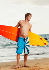Naklejka na ściany i meble Professional Surfer holding a Surf Board