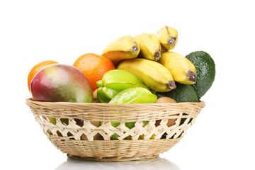 Assortment of exotic fruits in basket isolated on white