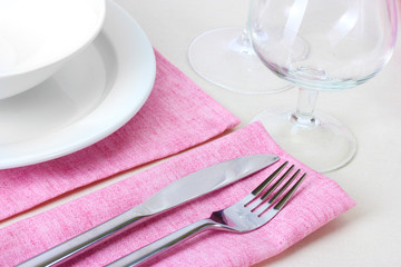 Table setting with fork, knife, plates and napkin