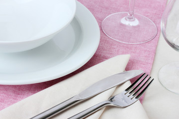 Table setting with fork, knife, plates, and napkin