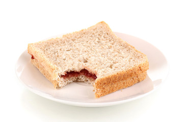 Bitten sandwich with jam on plate isolated on white