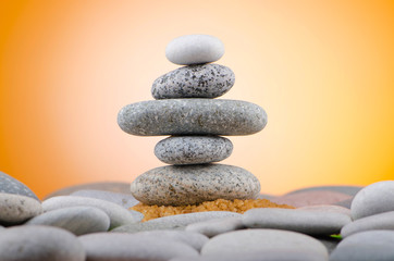Balanced pebbles with colour background