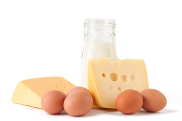 Different types of cheese, milk and eggs over white background