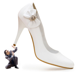 Woman domination concept with shoes and man