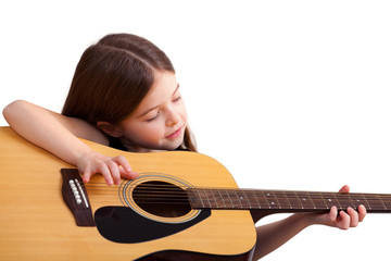 6 years old girl plays on the guitar, isolated on white