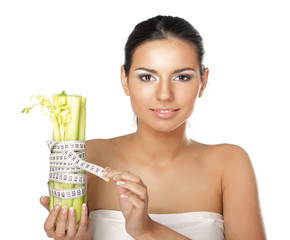 oung woman with vegetables and measuring tape