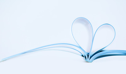 Pages of magazine curved into a heart shape