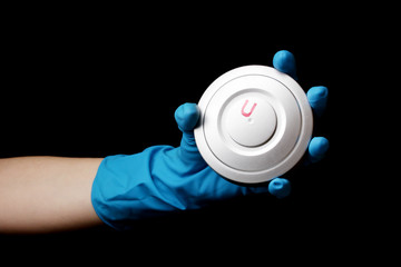 Uranium in hand isolated on black