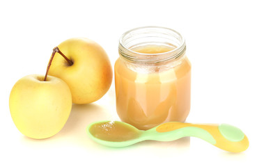 Jar of baby puree with apple and spoon isolated on white