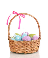 Colorful easter eggs in basket isolated on white