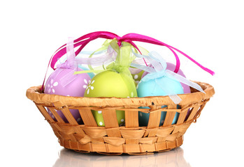 Colorful easter eggs in basket isolated on white