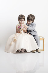 Two beautiful boys and girls in wedding dresses