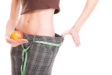Woman showing how much weight she lost