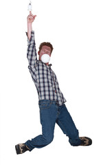 Man sticking his finger in the light socket