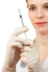 Nurse's hands in sterile gloves with syringe