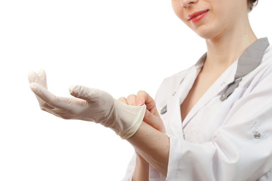 Nurse putting on sterile gloves