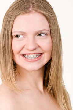 Beautiful young girl with brackets on teeth