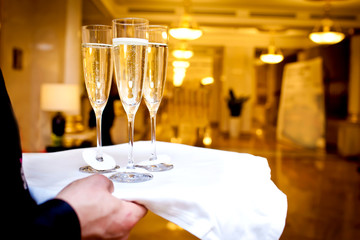 Full glasses of champagne on tray