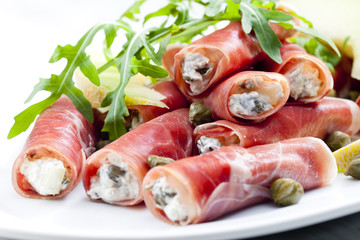 Parma ham rolls filled with cream cheese, Galia melon and capers