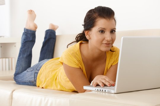 Young woman at home with laptop