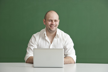 Teacher with smile and Laptop