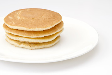 Four pancakes on a white plate