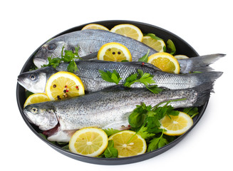 Fresh fishes with lemon, parsley and pepper
