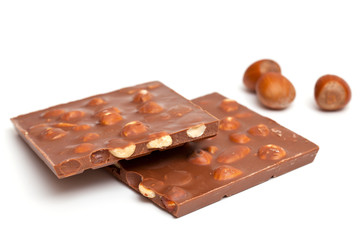 milk chocolate with hazelnuts isolated on white
