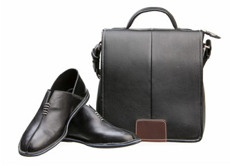 Pair of black men shoes and messenger bag over white