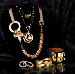 Golden jewelry on black background