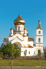Fototapeta na wymiar White church with gold domes