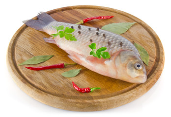 fish on wooden board with spice