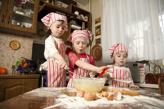 Three Little Chefs Enjoying In The Kitchen Making Big Mess. Litt