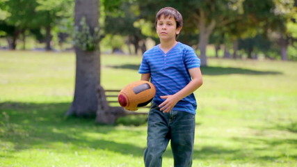 Smiling boy playing rugby - Powered by Adobe